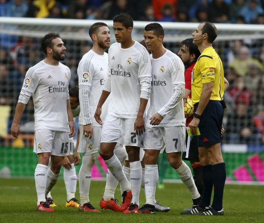 Real Madrid's Raphael Varane leaves the field next to teammate Cristiano Ronaldo after receiving two yellow cards